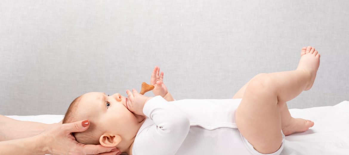 Little baby receiving osteopathic treatment of head and neck