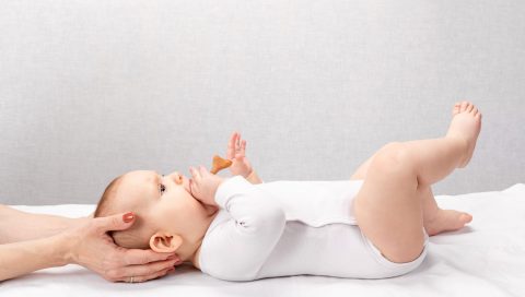 Little baby receiving osteopathic treatment of head and neck