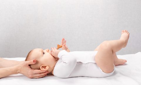 Little baby receiving osteopathic treatment of head and neck